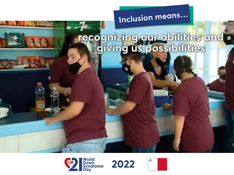 Three young people with Down syndrome stand in a row at the counter of a cafeteria.