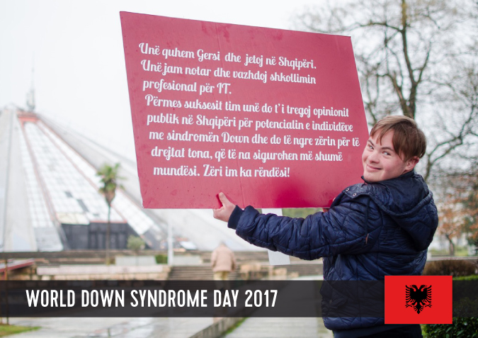 Young man with Down syndrome holding a sign with his statement to WDSD 2017.