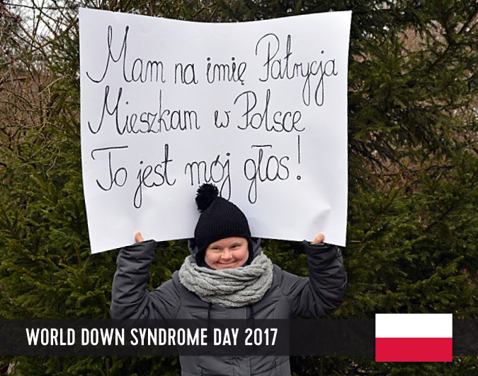 Young woman with Down syndrome holding a sign above her head with her statement to WDSD 2017