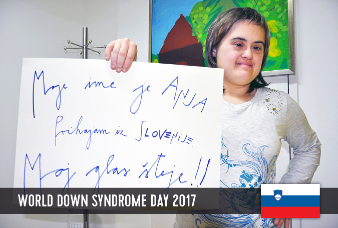 Young women with Down syndrome holding a sign with her statement