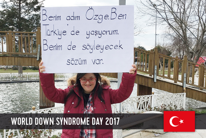 Young Turkish lady with DS holding a sign above her head with a statement on WDSD 2017