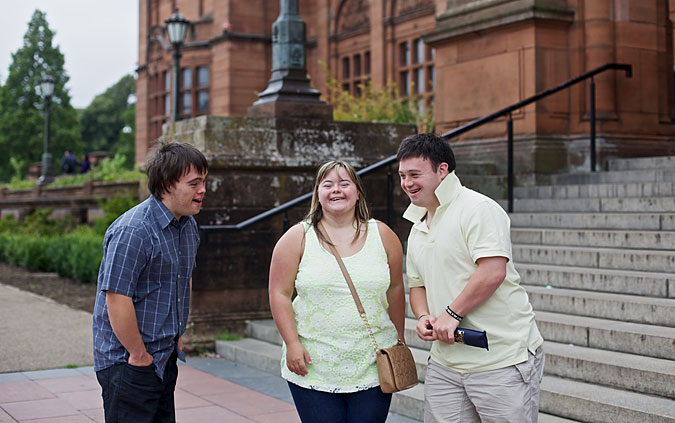 This year’s World Down Syndrome Congress Lead Commissioners, Andrew MacIntyre, Sam Ross and Stuart Campbell, all of whom have Down’s syndrome, stand in front of Kelvingrove Art Museum in Glasgow