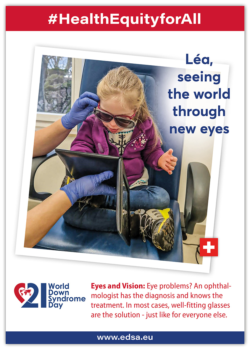 A girl with Down syndrome sits on a chair in an ophthalmologist’s practice. She is wearing dark stereoscopic glasses and looking at pictures on a tablet held out to her by an orthoptist.