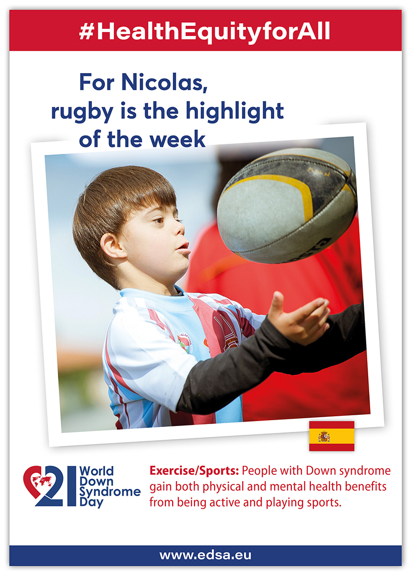 A boy with Down syndrom plays with a rugby ball in front of his face.